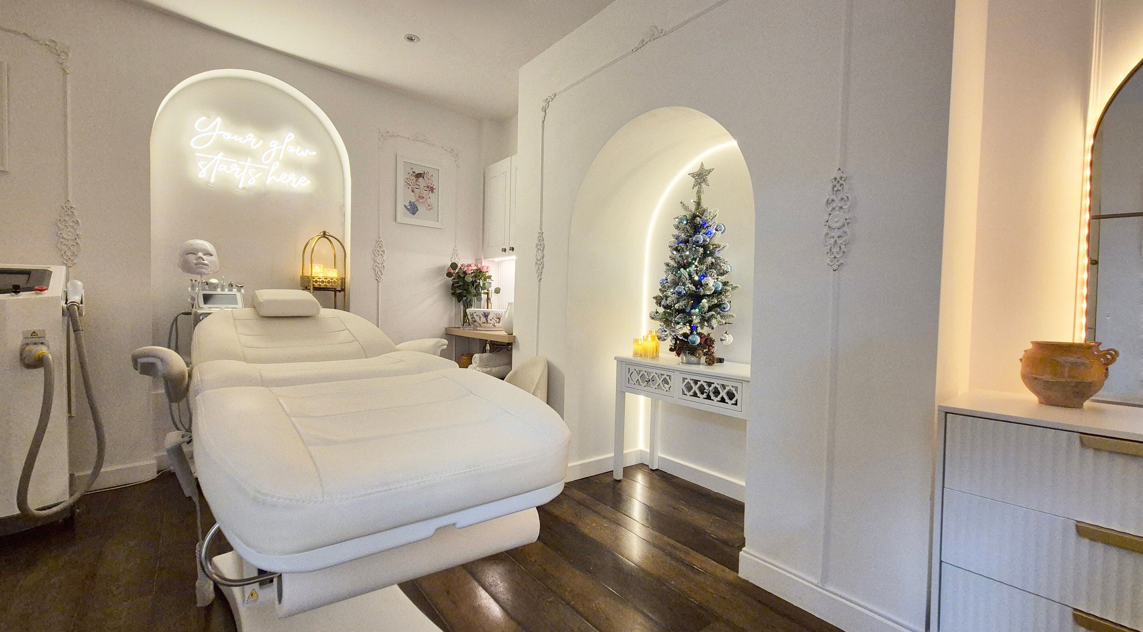 Luxurious treatment room at Skin Well Aesthetics Boutique, London, England, GB with plush bed and elegant decor.