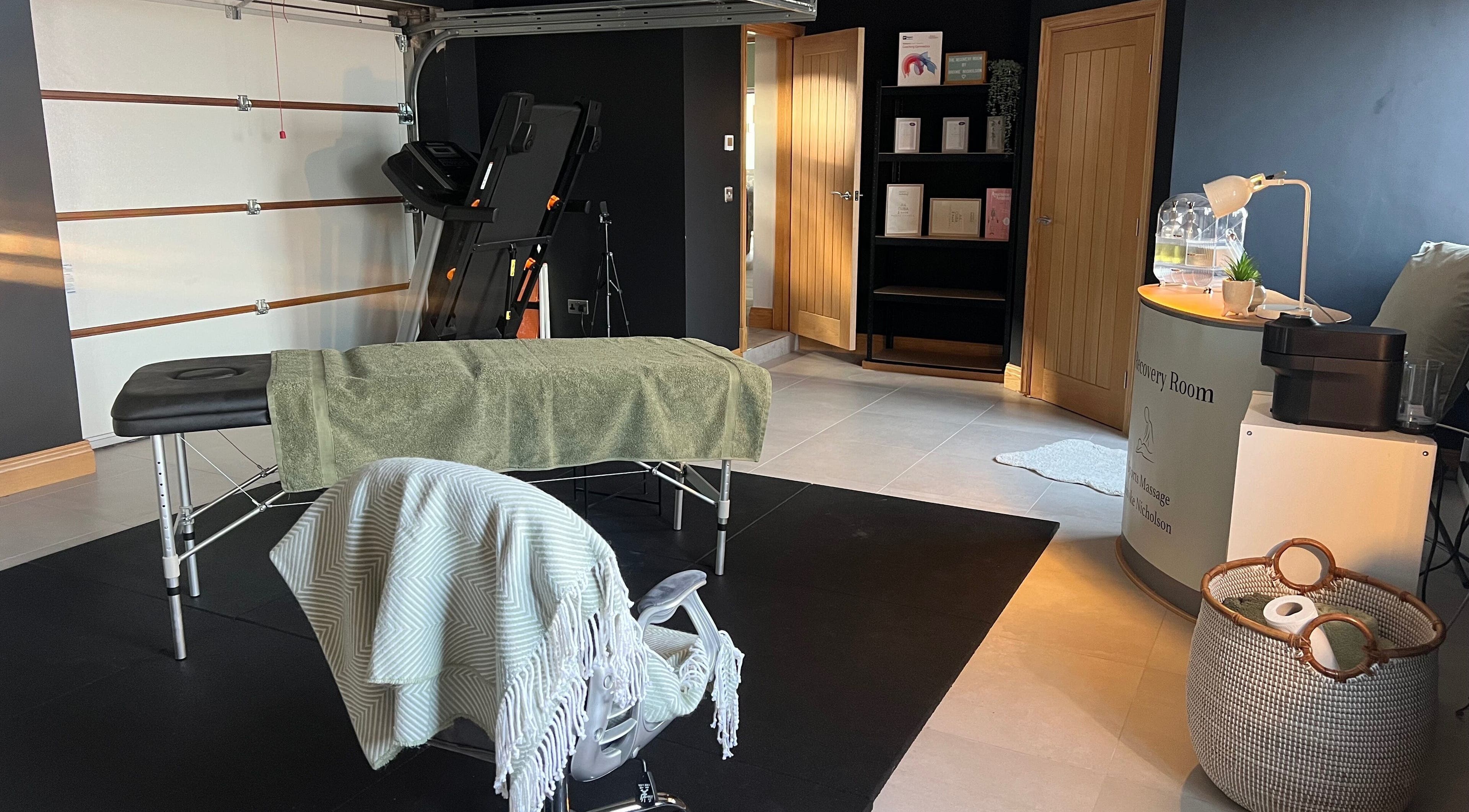 Relaxing massage room at The Recovery Room, Doncaster, England, GB, featuring a massage table and calming decor.