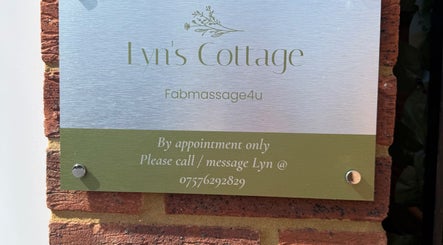 Sign for Lyns Cottage - Fab Massage 4 u, Southampton, England, GB, on a brick wall.