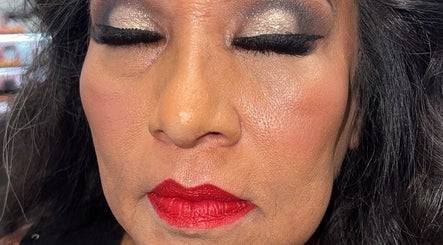 Elegant makeup with bold red lips and shimmering eyeshadow at Browsbybre, Upland, California, US.