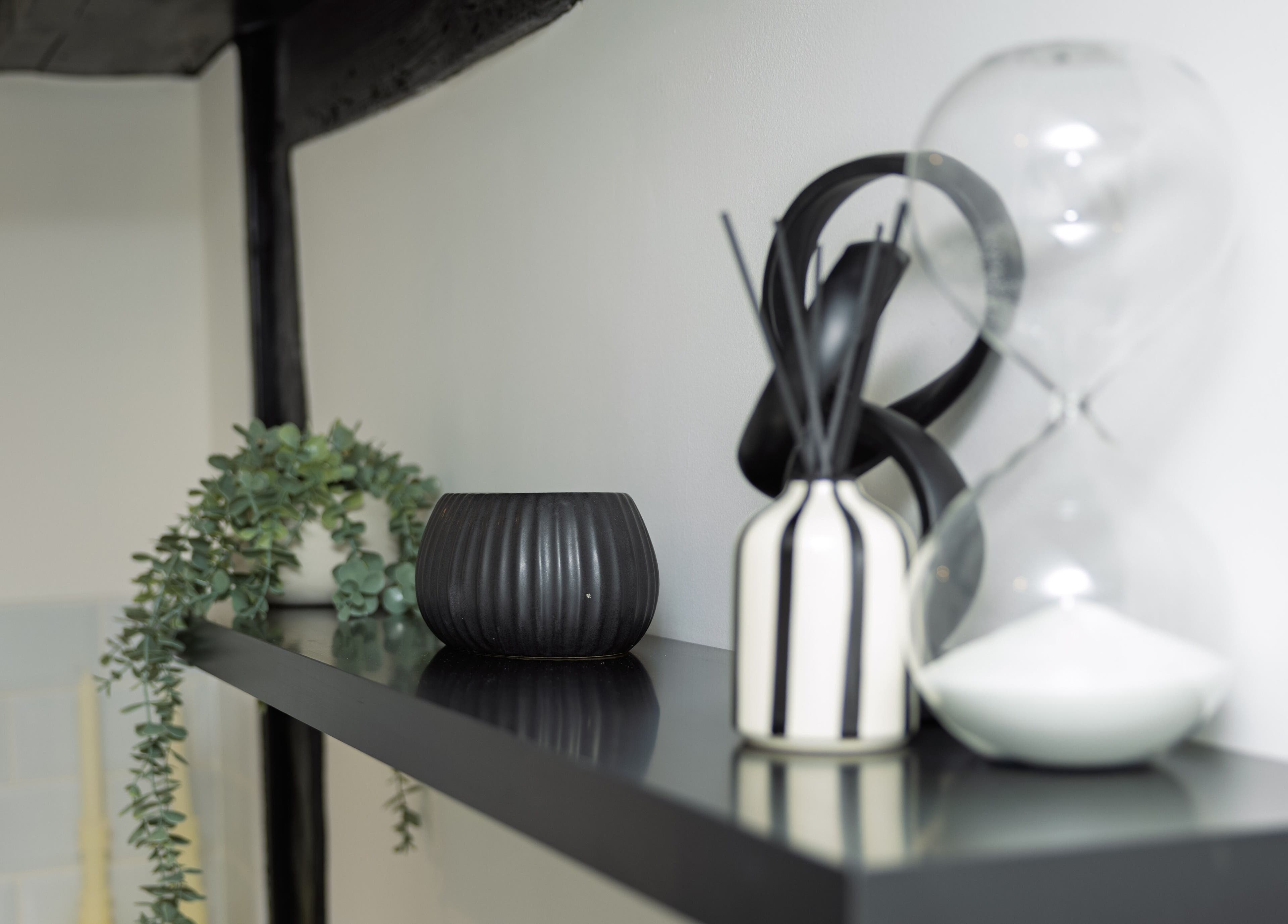 Elegant decorative items on a black shelf at The Sigma Clinic, Chelmsford, England, GB.