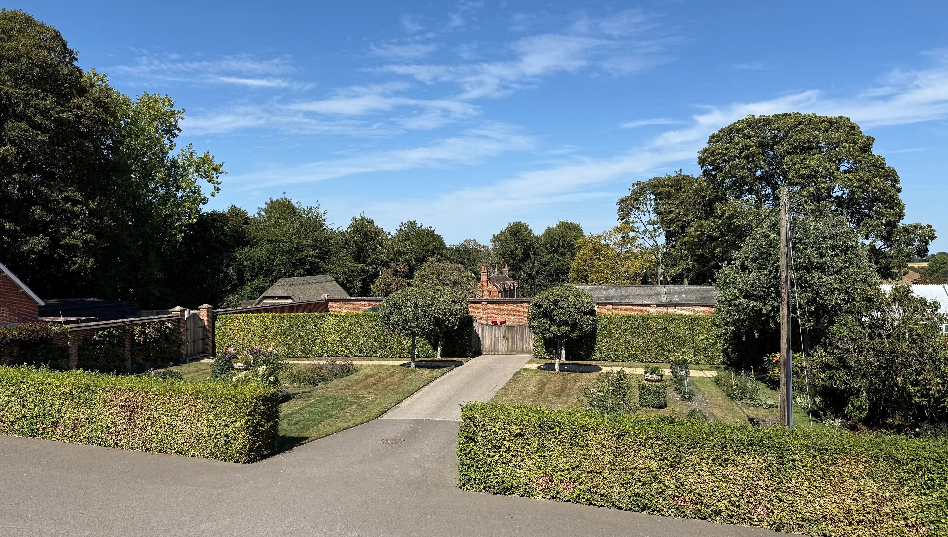 Beautiful garden view at Chloë Jane Aesthetics, Farleigh Wallop, England, GB under a clear blue sky.