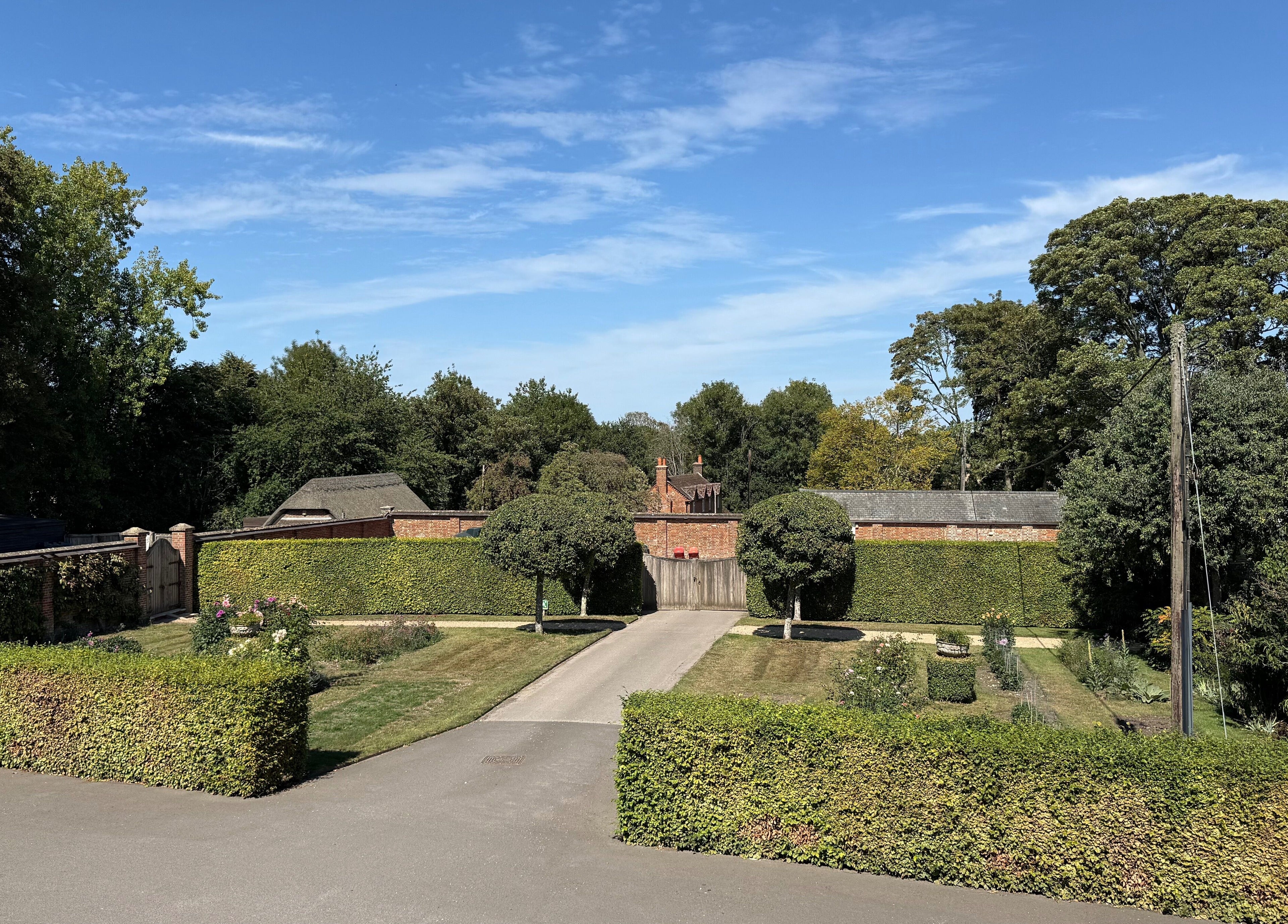 Beautiful garden view at Chloë Jane Aesthetics, Farleigh Wallop, England, GB under a clear blue sky.