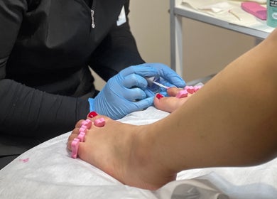 Professional pedicure at Holmaibeauty, Wellington, Wellington Region, NZ with blue gloves and pink separators.