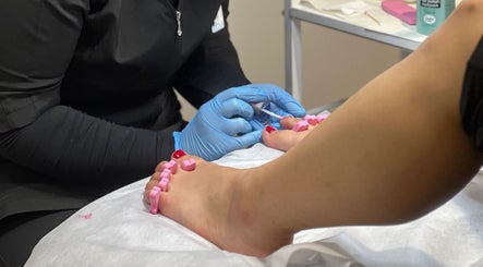 Professional pedicure at Holmaibeauty, Wellington, Wellington Region, NZ with blue gloves and pink separators.