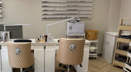 Elegant nail salon interior at Ann’s Nails and Beauty, Ruddington, England, GB featuring plush chairs and polish wall.