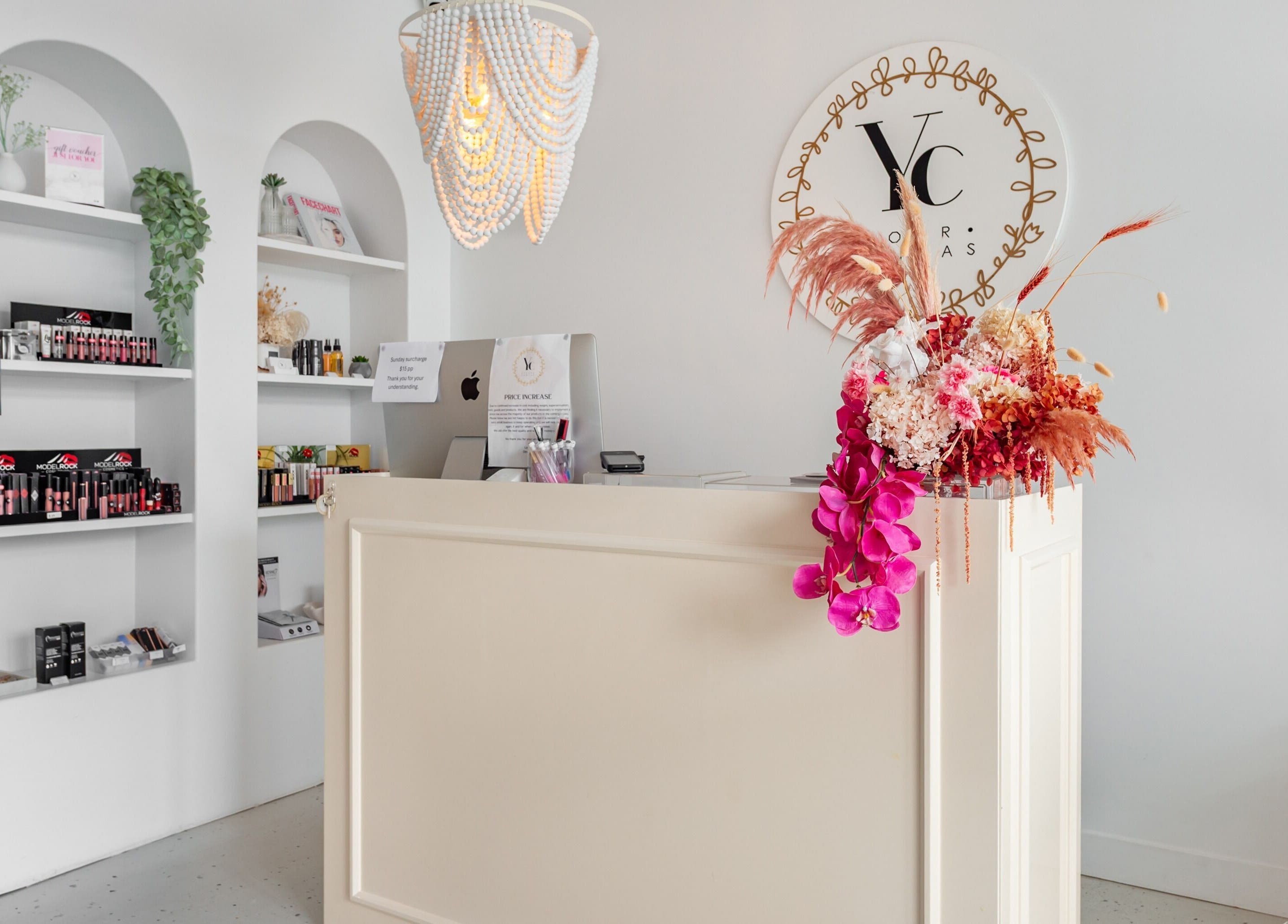 Reception desk with floral decor at Your Canvas, Hermit Park, Queensland, AU.