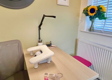 Cozy nail station at The Harrogate Nail Artist in Harrogate, England, GB with a bright desk and sunflowers.