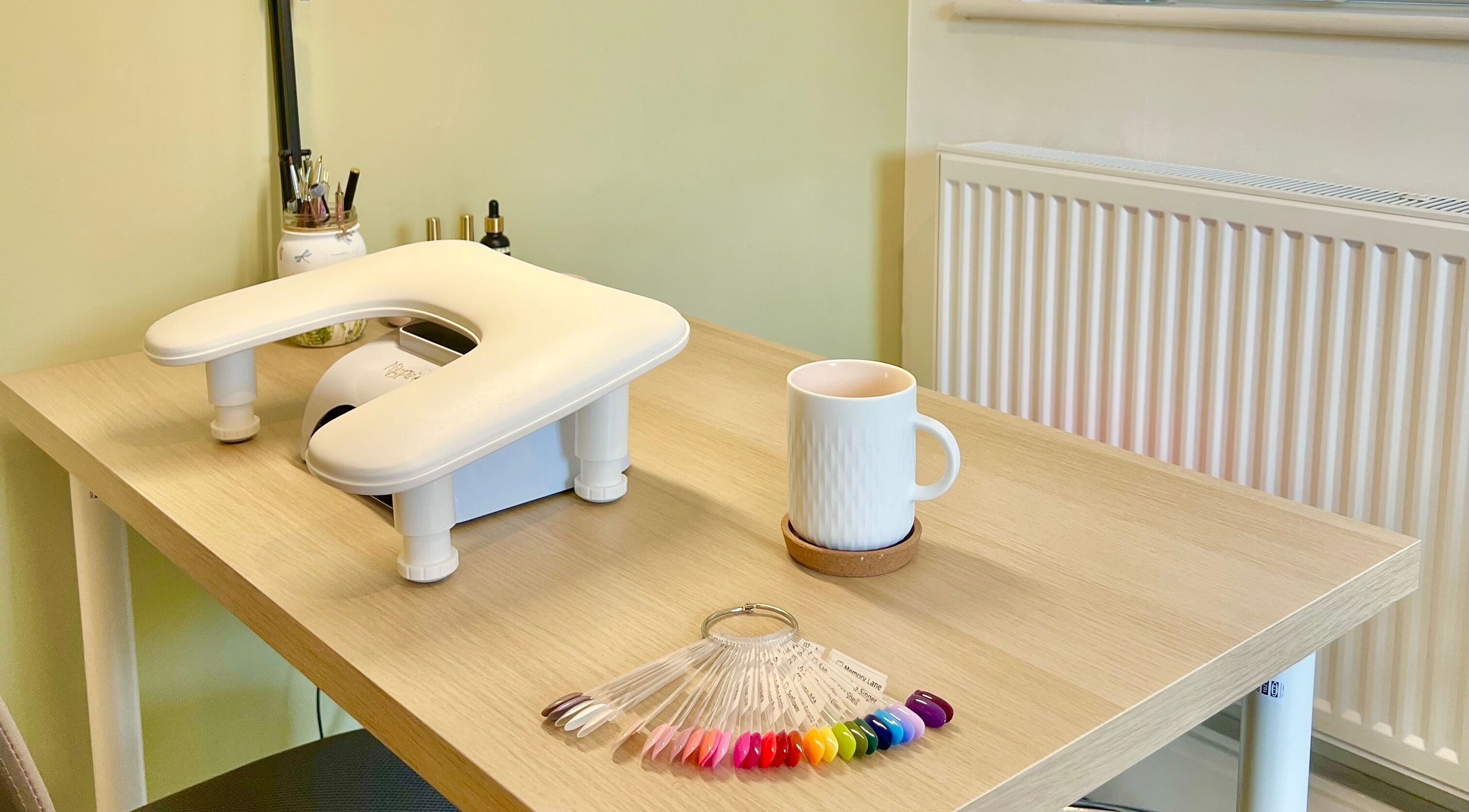 Cozy nail station at The Harrogate Nail Artist in Harrogate, England, GB, showcasing vibrant polish options.
