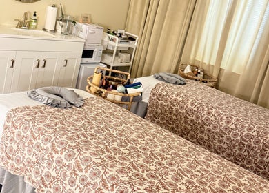 Relaxing treatment room at Moonme Spa, Newport Beach, California, US, features twin massage tables.