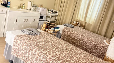 Relaxing treatment room at Moonme Spa, Newport Beach, California, US, features twin massage tables.