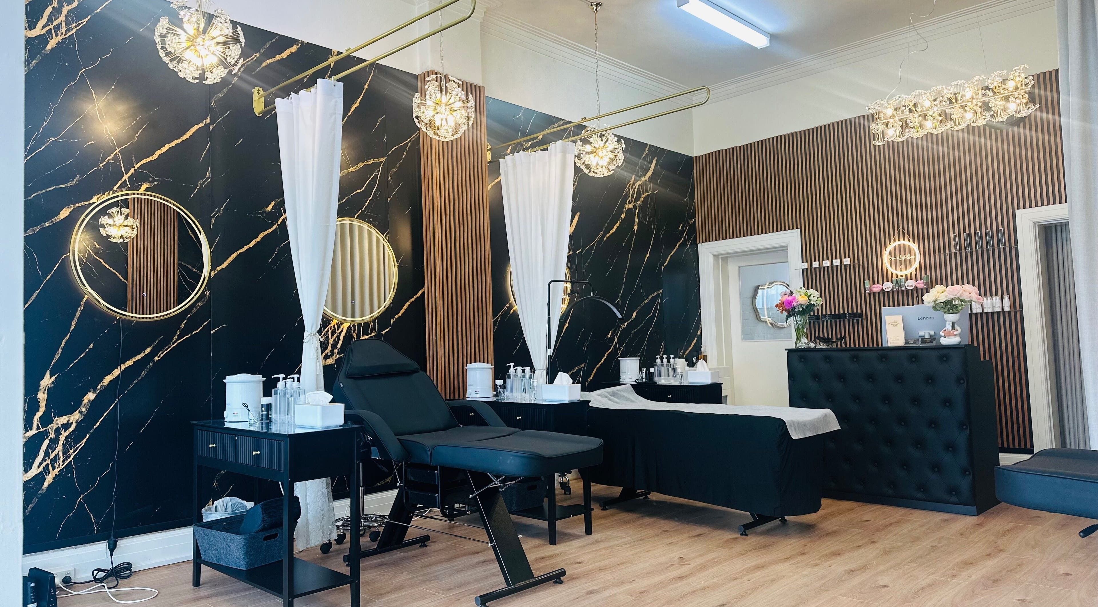 Elegant beauty salon interior at Brow & Lash Queen, Melbourne, Victoria, AU with chic decor and treatment area.