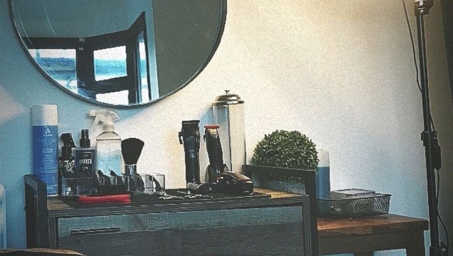 Modern grooming station at CutByOC, Saltdean, England, GB featuring barber tools and chic decor.