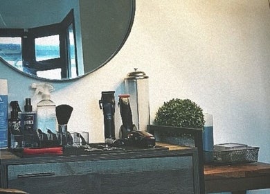 Modern grooming station at CutByOC, Saltdean, England, GB featuring barber tools and chic decor.