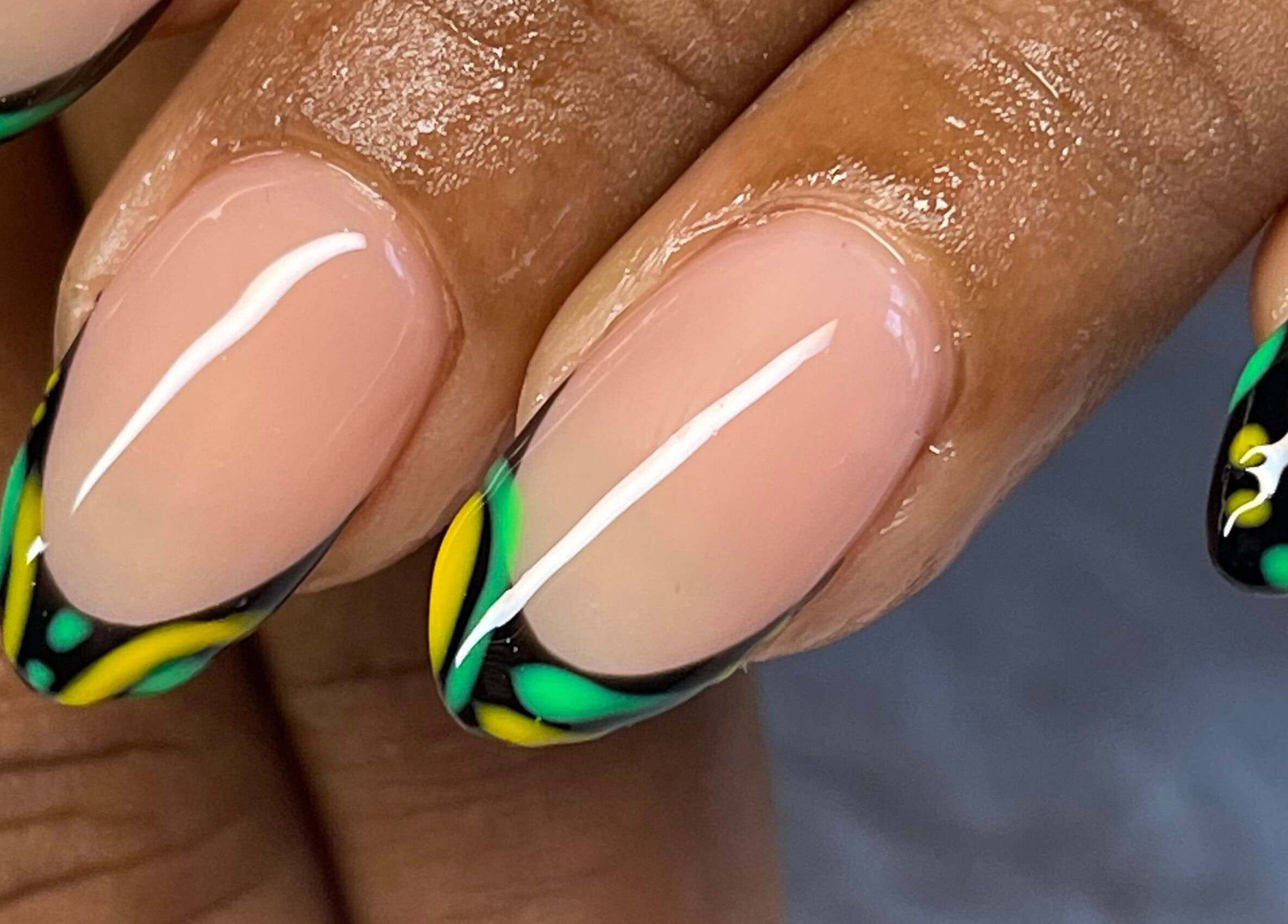 Vibrant green and yellow nail art at Elegant Tips, Ocho Rios, JM, showcasing expert manicure designs.