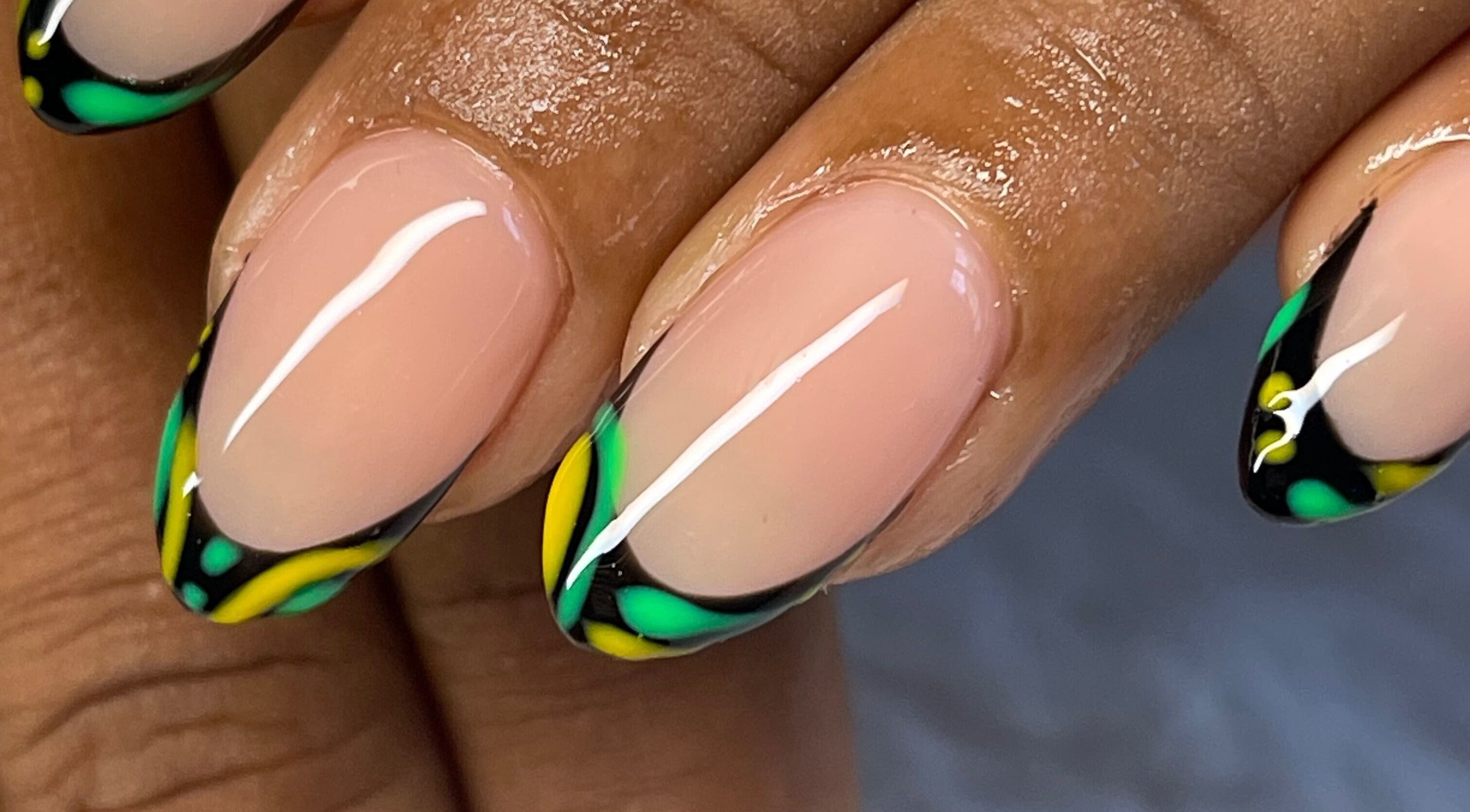 Vibrant green and yellow nail art at Elegant Tips, Ocho Rios, JM, showcasing expert manicure designs.