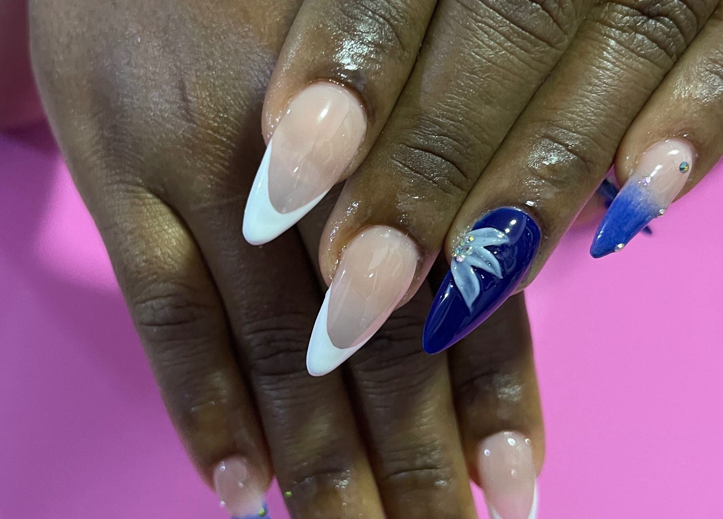 Elegant Tips Ocho Rios, JM showcases chic nail art with blue and white designs.