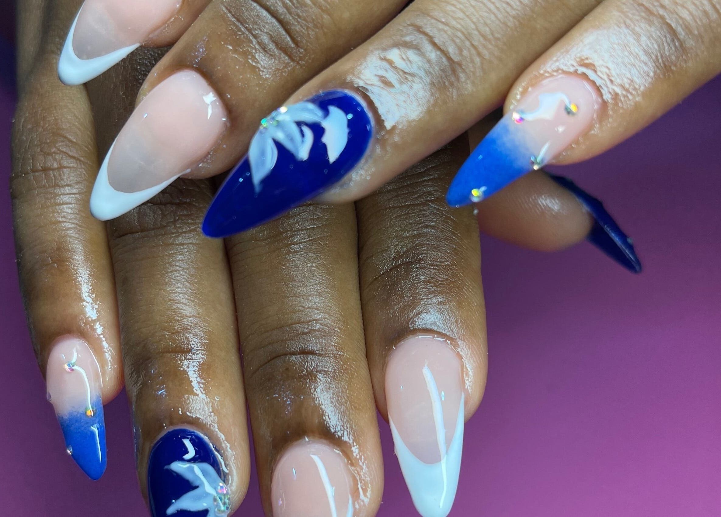 Stunning blue and white nail art design at Elegant Tips, Ocho Rios, JM.