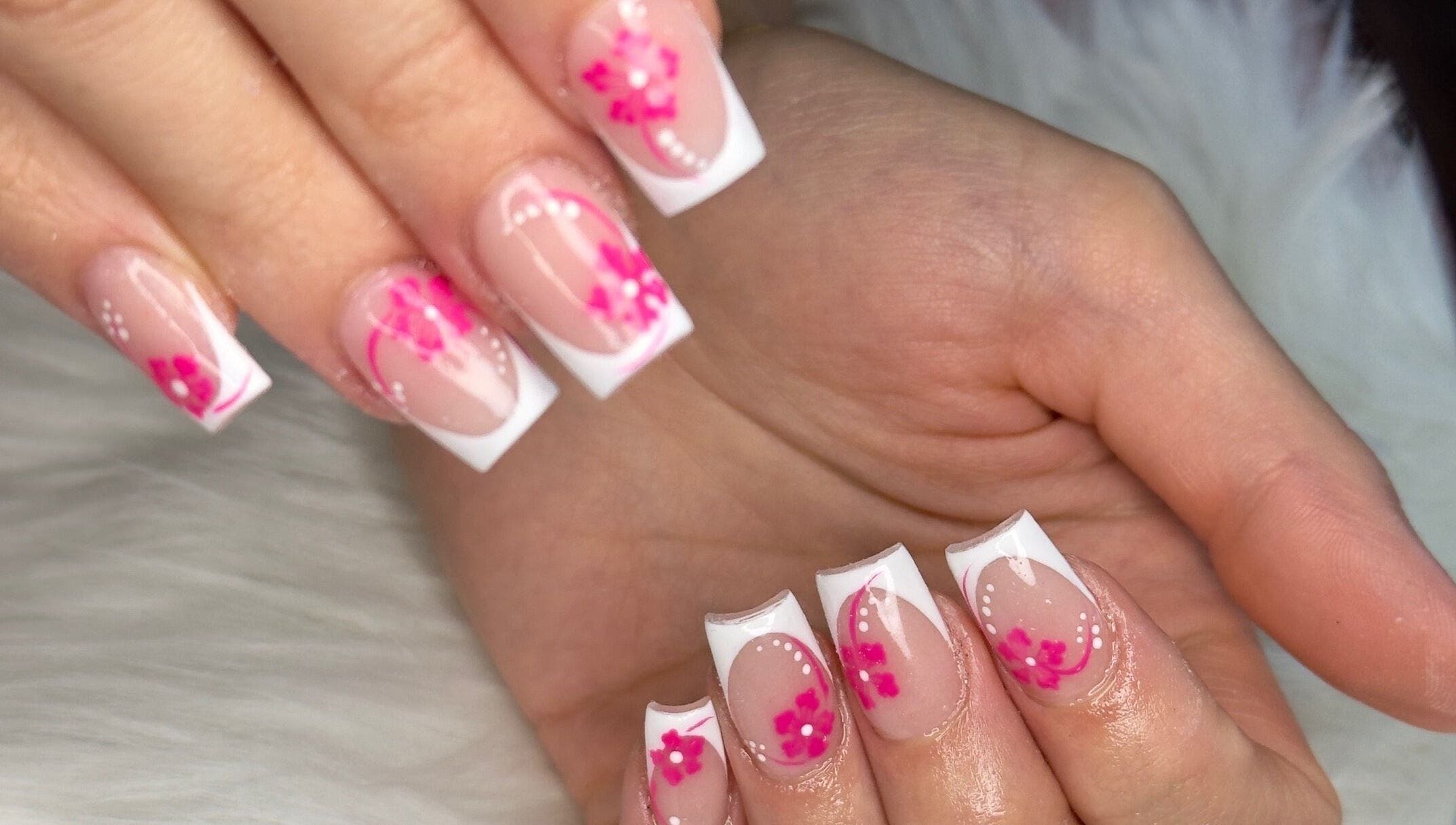 Elegant floral nail art at Ooh La La Nail Bar in Richardson, Texas, US, showcasing intricate pink designs.