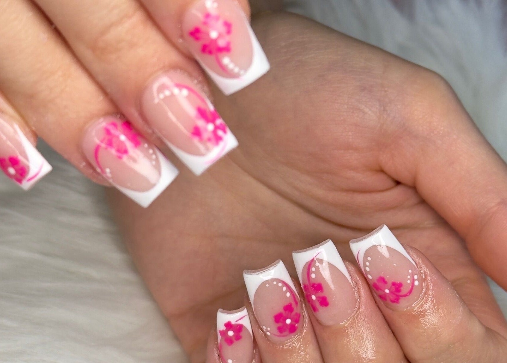 Elegant floral nail art at Ooh La La Nail Bar in Richardson, Texas, US, showcasing intricate pink designs.