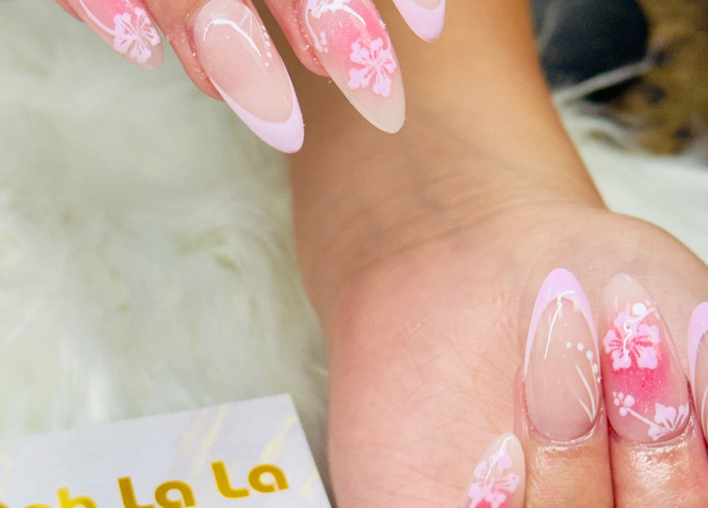 Elegant pink floral nail art at Ooh La La Nail Bar in Richardson, Texas, US, showcasing intricate designs.