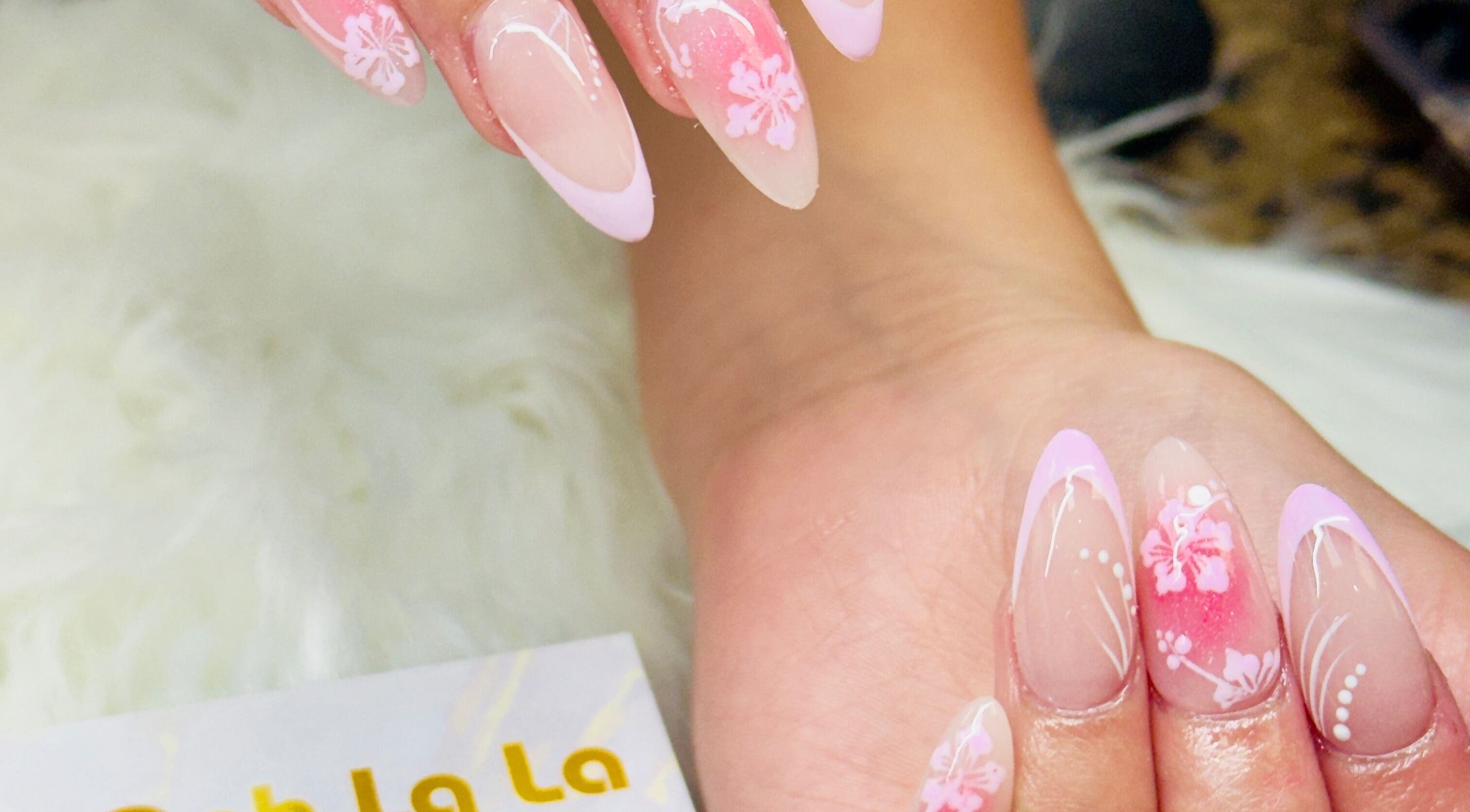 Elegant pink floral nail art at Ooh La La Nail Bar in Richardson, Texas, US, showcasing intricate designs.