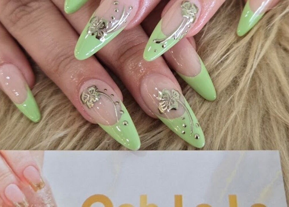Stylish green manicured nails with floral accents at Ooh La La Nail Bar, Richardson, Texas, US.