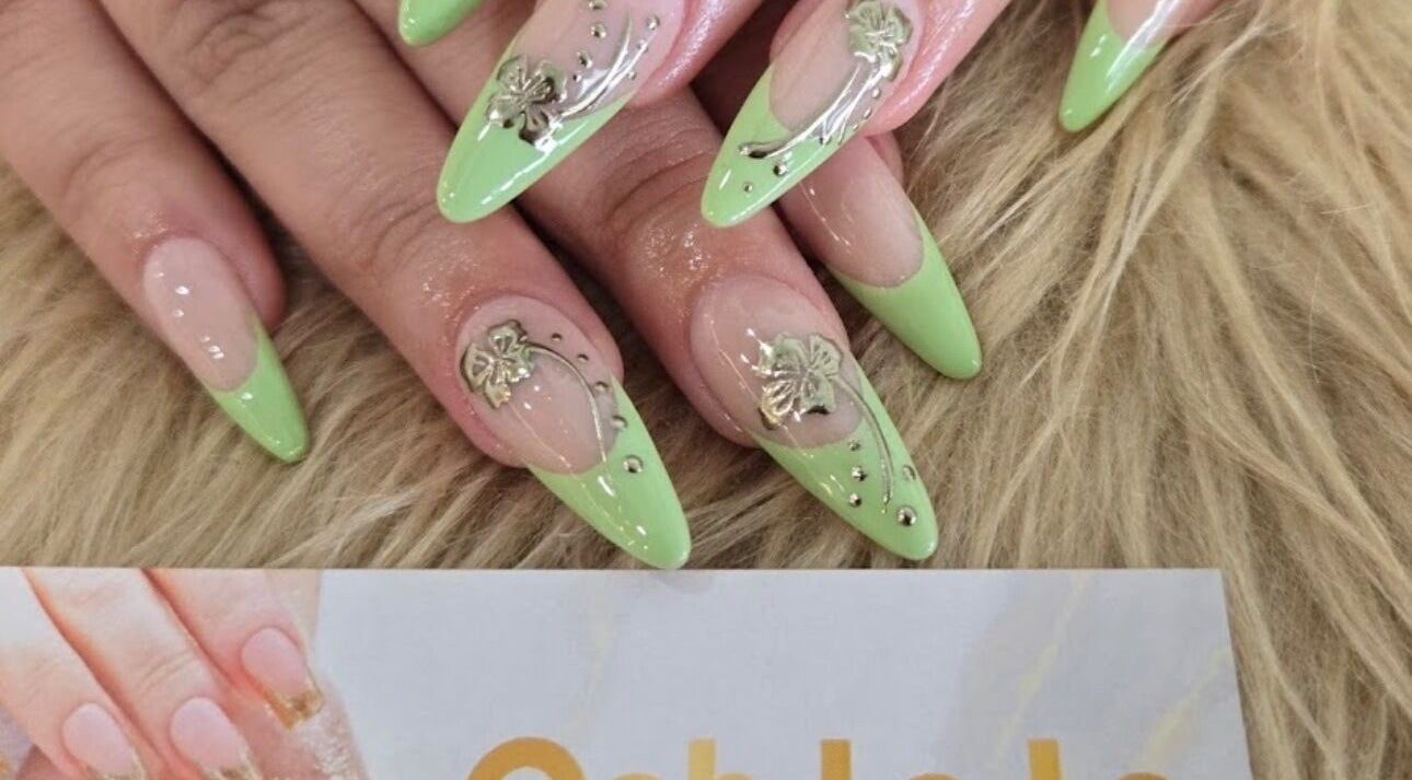Stylish green manicured nails with floral accents at Ooh La La Nail Bar, Richardson, Texas, US.