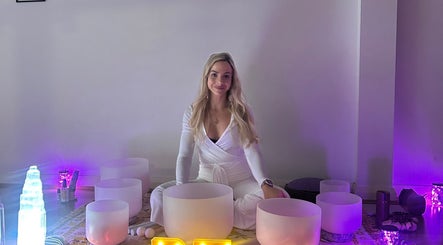 A serene woman with crystal bowls at Butterfly Energy, Duncraig, Western Australia, AU.