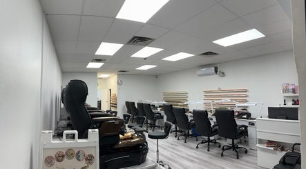 Modern interior of Elite Nails, Lower Sackville, Nova Scotia, CA, featuring stylish pedicure chairs and nail stations.