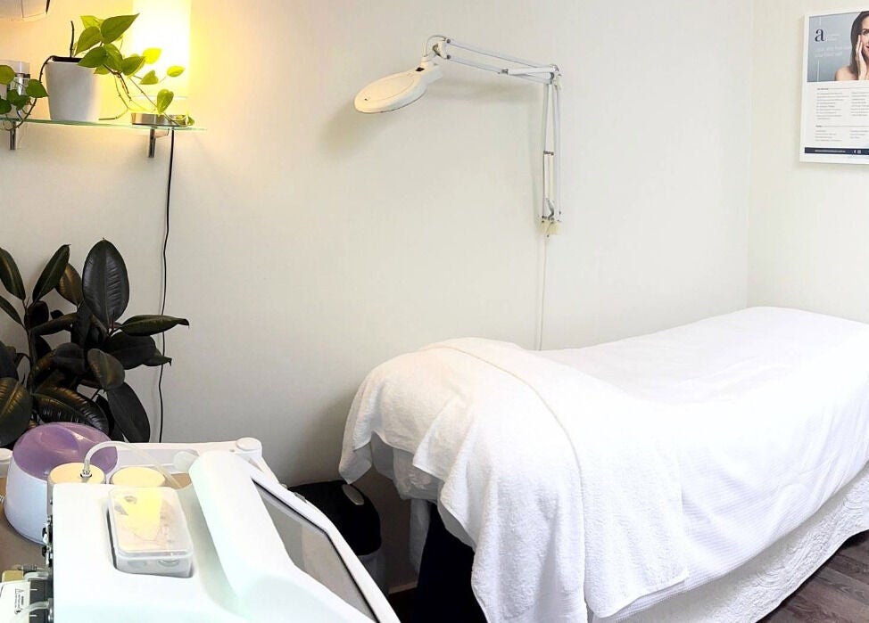 Tranquil treatment room at Advanced Skin and Laser, Mount Eliza, Victoria, AU with massage bed and plants.