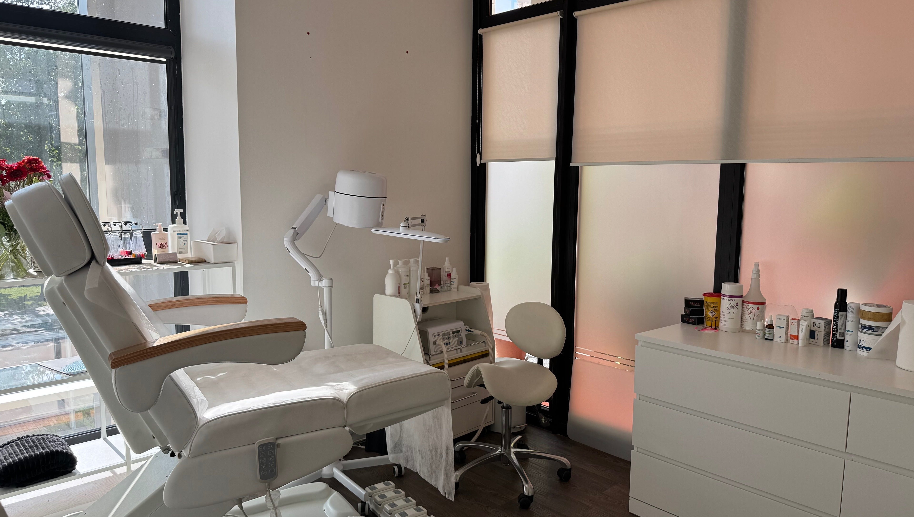 Modern podology room at Jelgavas Podologs in Jelgava, LV, featuring a comfortable chair and wellness products.