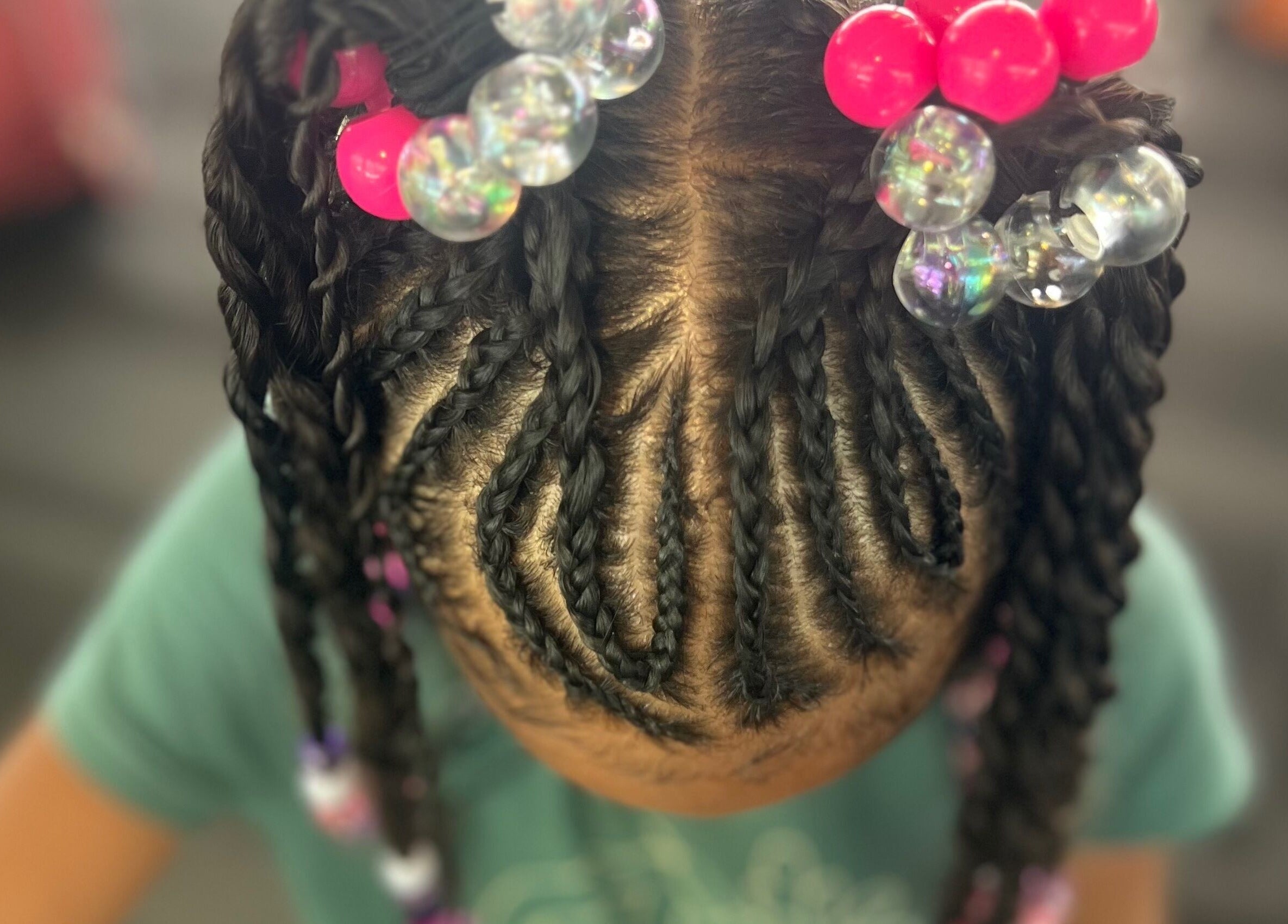 Intricate braids with colorful beads at Undefined Beauty in Tulsa, Oklahoma, US.