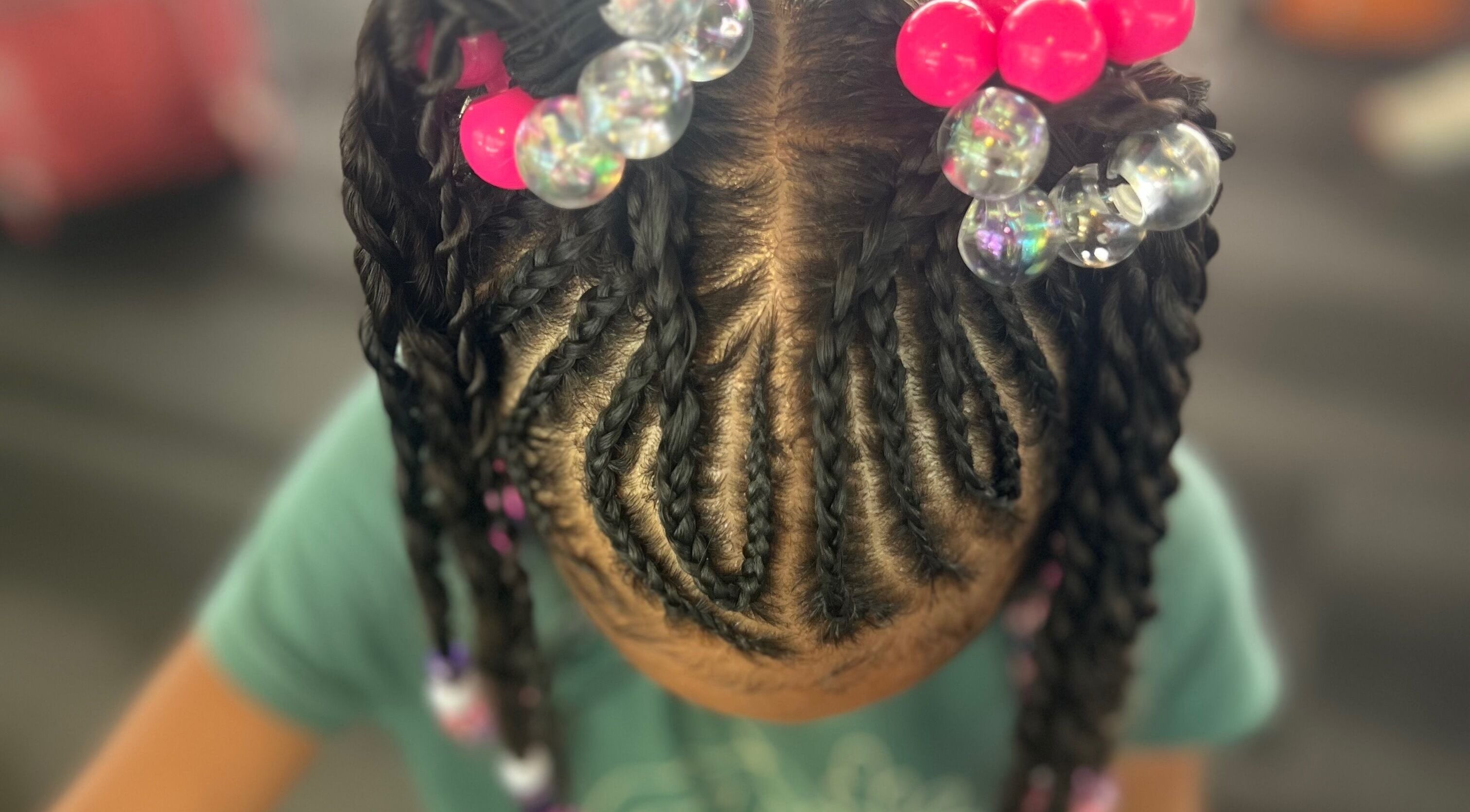 Intricate braids with colorful beads at Undefined Beauty in Tulsa, Oklahoma, US.