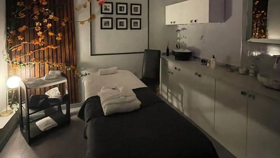 Tranquil treatment room at PureLi Skin Clinic in London, England, GB, featuring a massage bed and warm decor.