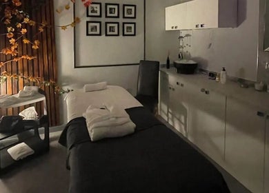 Tranquil treatment room at PureLi Skin Clinic in London, England, GB, featuring a massage bed and warm decor.