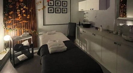 Tranquil treatment room at PureLi Skin Clinic in London, England, GB, featuring a massage bed and warm decor.