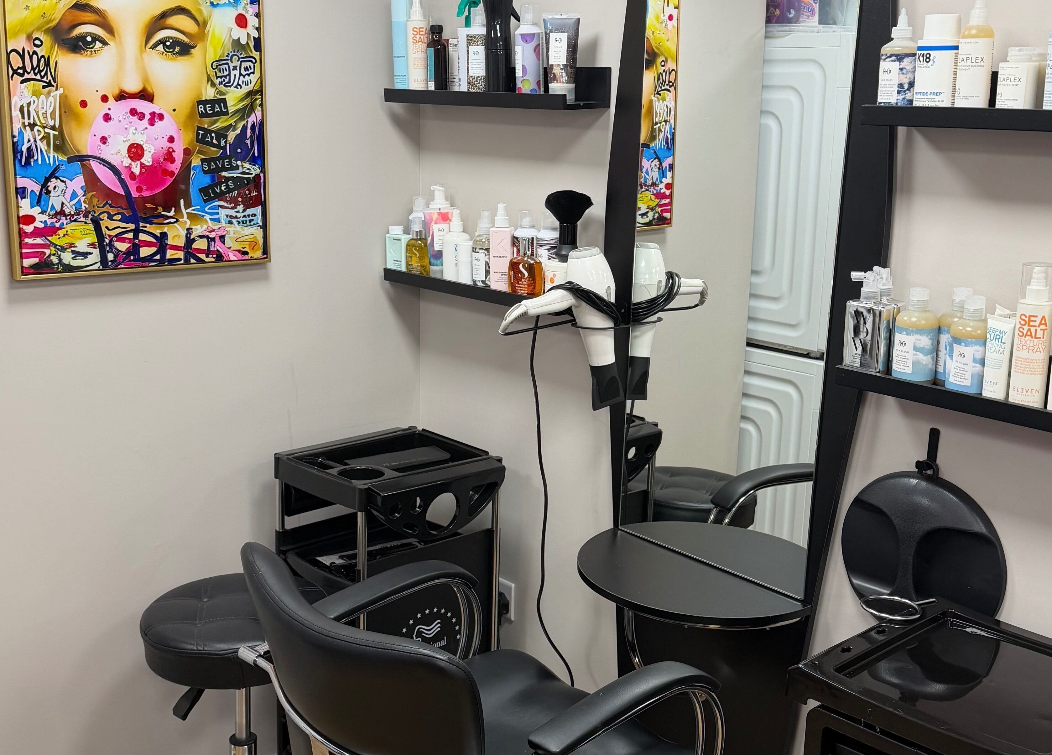 Modern styling station at One2one salon in Dublin, County Dublin, IE with vibrant artwork and hair products.