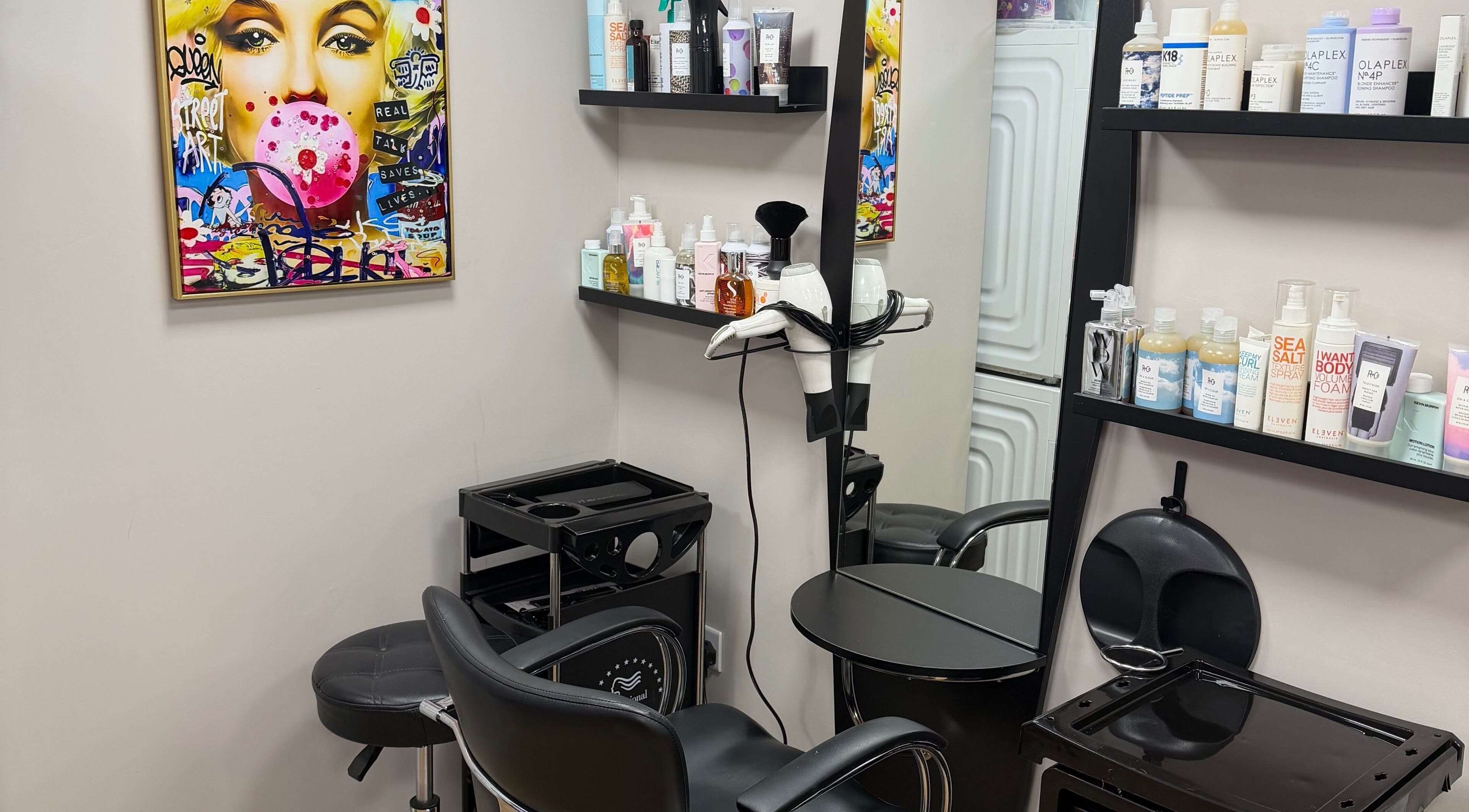 Modern styling station at One2one salon in Dublin, County Dublin, IE with vibrant artwork and hair products.