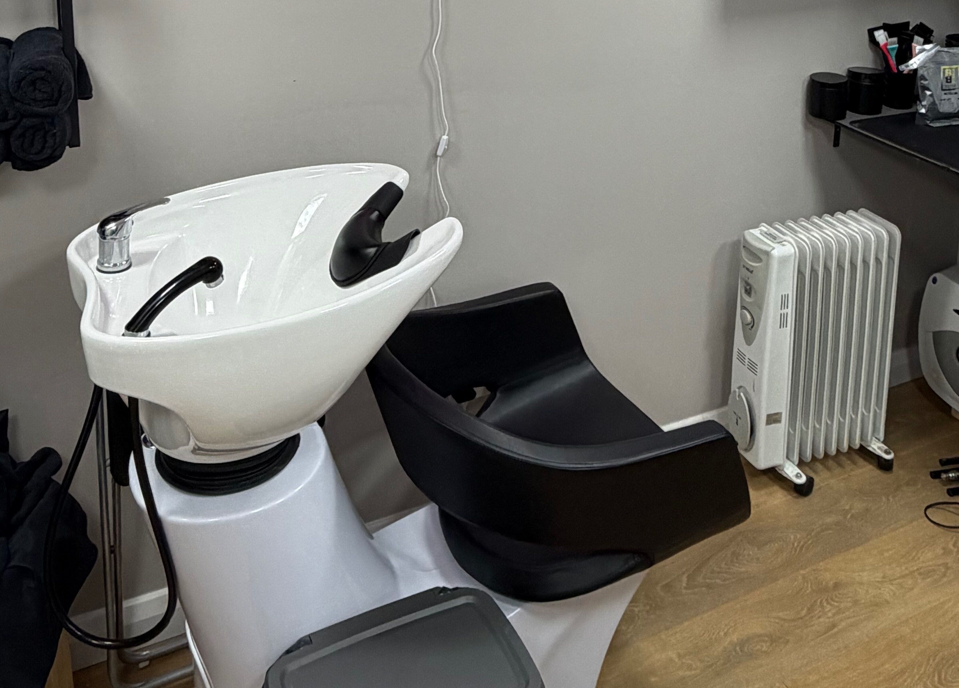 Modern washing station at One2one salon, Dublin, County Dublin, IE, with black and white fixtures.