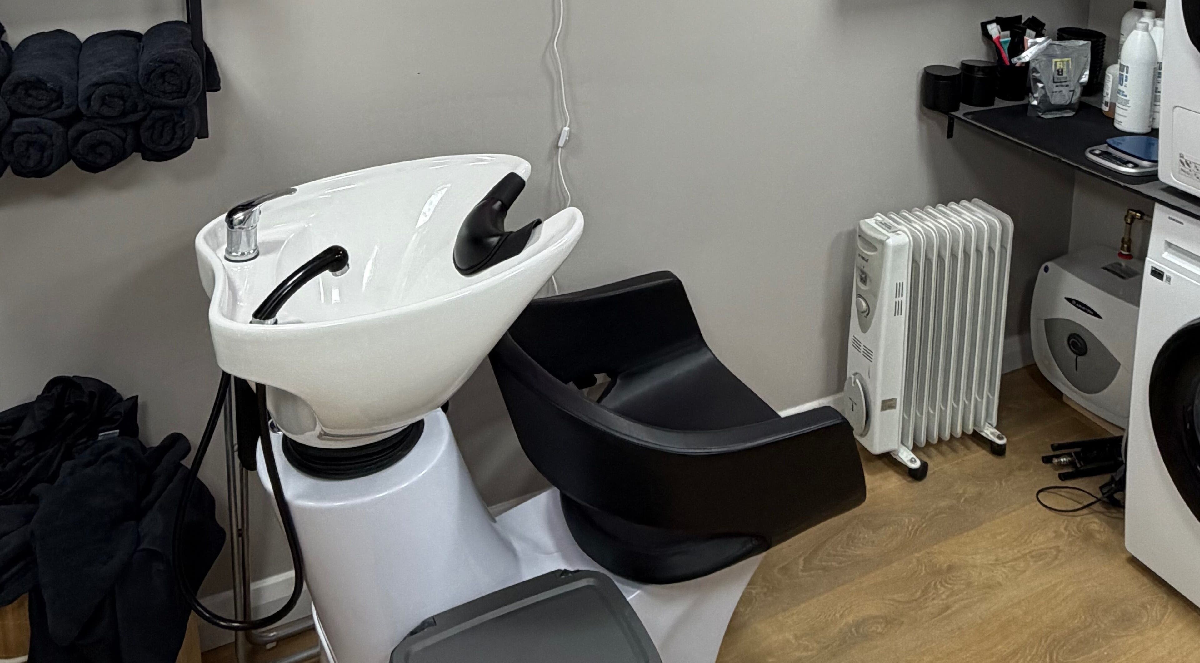 Modern washing station at One2one salon, Dublin, County Dublin, IE, with black and white fixtures.