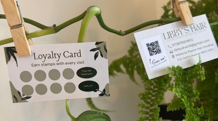 Libby’s Hair loyalty card and contacts in Worthing, England surrounded by greenery.