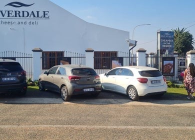 Front view of KM Beauty Lounge, Randburg, Gauteng, ZA showcasing parked cars and entrance.
