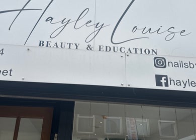 Front signage of Hayley Louise Beauty & Education located in Hyde, England, GB displaying contact details.
