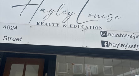 Front signage of Hayley Louise Beauty & Education located in Hyde, England, GB displaying contact details.