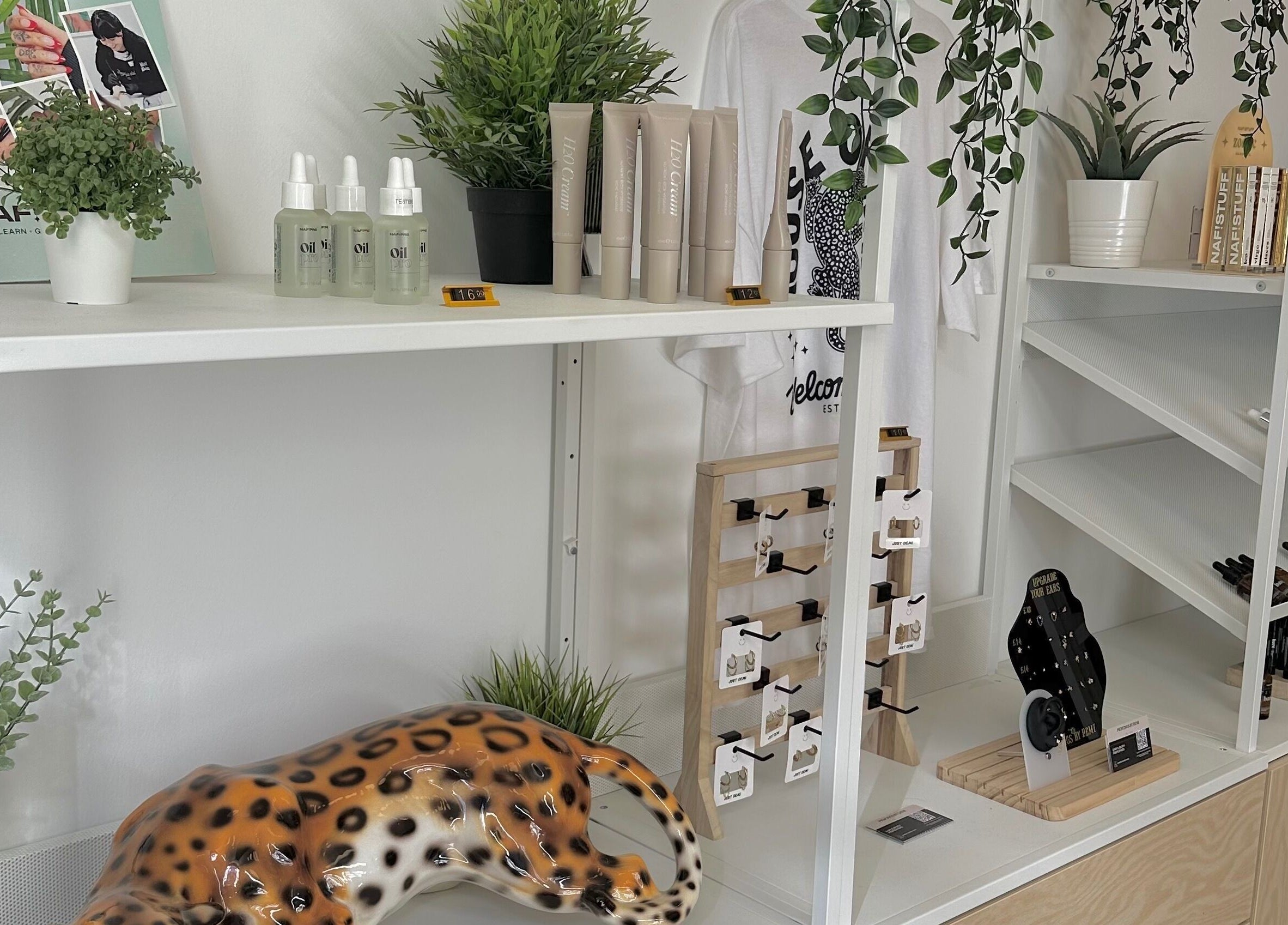 LMS Nails in Glasgow, Scotland features a chic display with beauty products and indoor plants.