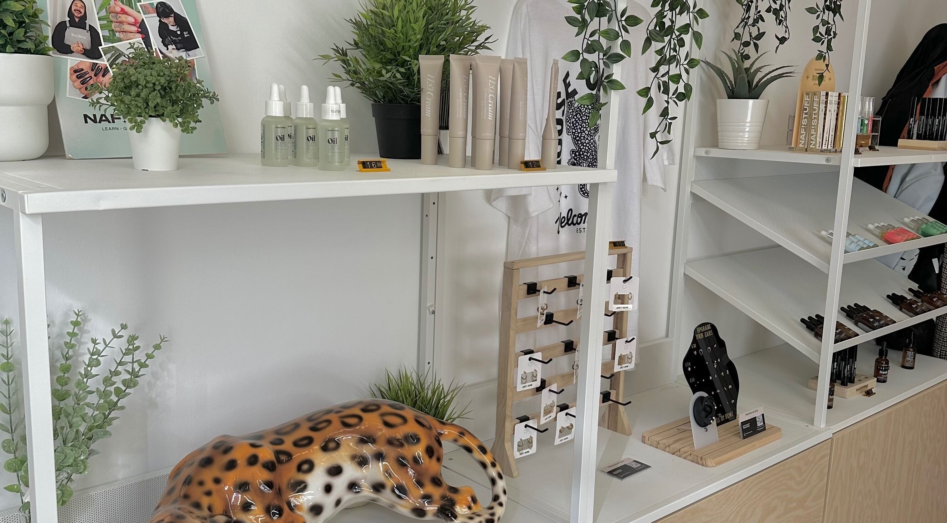 LMS Nails in Glasgow, Scotland features a chic display with beauty products and indoor plants.