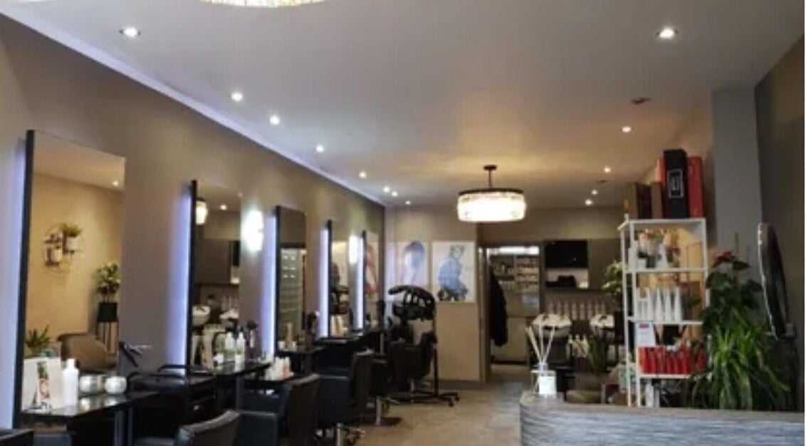 Interior of Tomrc Hair, a sleek salon in Alvechurch, England, GB with modern decor and ample seating.