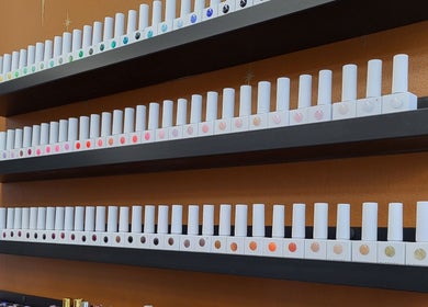 Shelves with colorful nail polishes at Boho Glow Nails, Launceston, England, GB, showcasing a wide polish range.