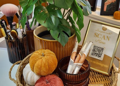 Chic tabletop decor at Boho Glow Nails, Launceston, England, GB showcasing brushes and autumnal accents.